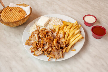 Menu kebab plate with chicken meat, fried potatoes, fresh cheese and basmati rice with pita bread...