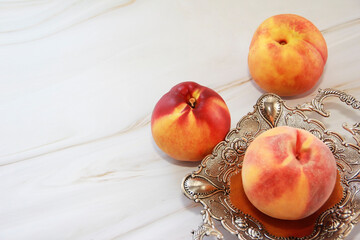 natural peach fruits in a decorative plate