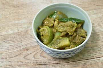 spicy boiled slice beef with eggplant in coconut milk green curry soup on bowl eat couple plain rice