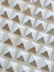 Patterned grey wall decorated with sgraffito ornamentation in Segovia, Spain. Vertical photo