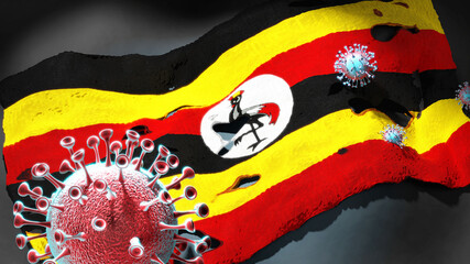 Covid in Uganda - coronavirus attacking a national flag of Uganda as a symbol of a fight and struggle with the virus pandemic in this country, 3d illustration