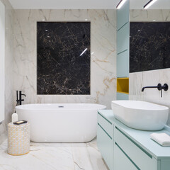 Stylish bathroom with marble tiles and blue furniture