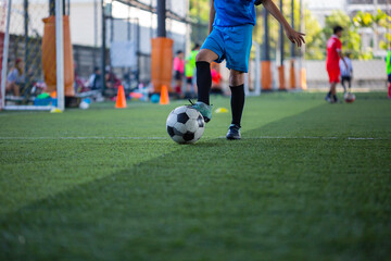Obraz premium Children playing control soccer ball tactics on grass field with for training
