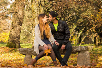 couple sitting on a bench in autumn park