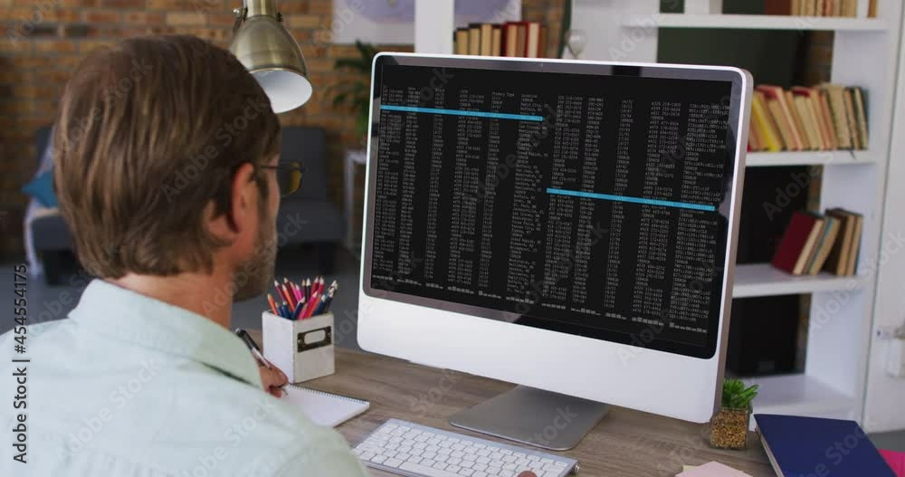 Poster caucasian man sitting at desk watching coding data processing on computer screen