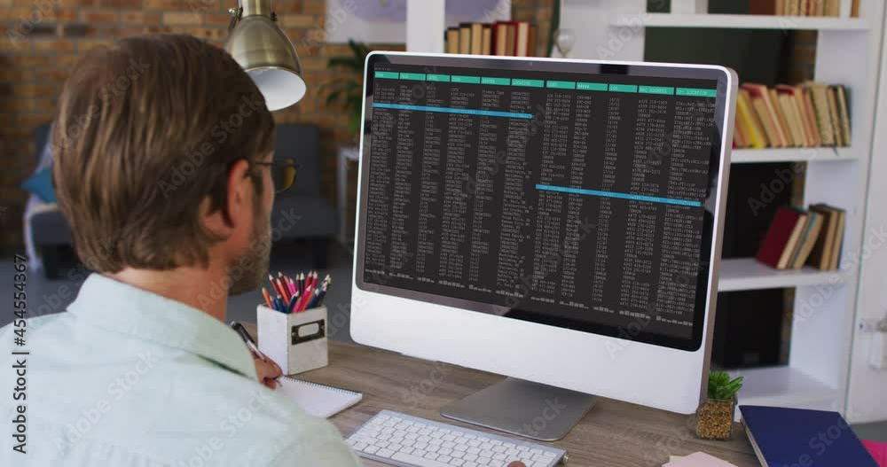 Poster caucasian man sitting at desk watching coding data processing on computer screen