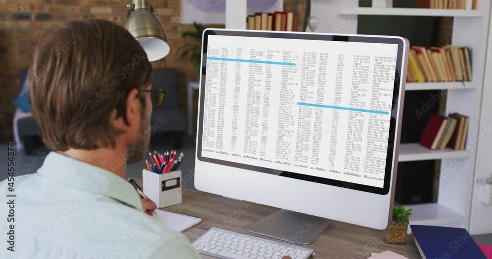 Poster caucasian man sitting at desk watching coding data processing on computer screen