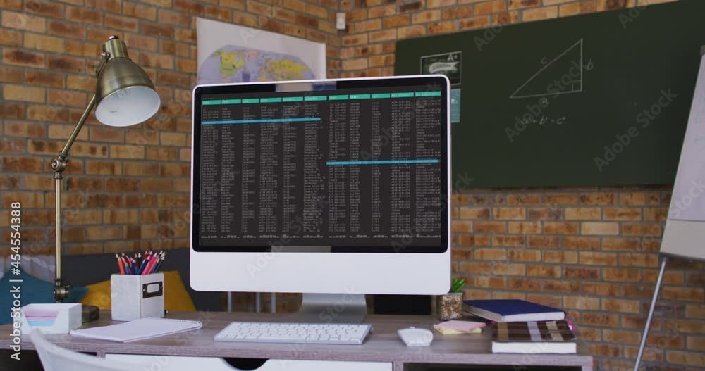 Poster computer screen with data processing standing on desk in office