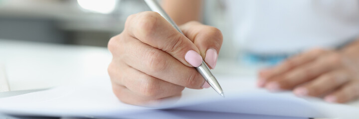 Woman hand makes entries in diary closeup