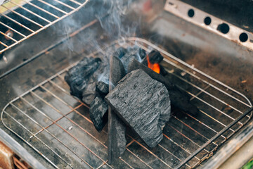 Burning charcoal with flame and smoke