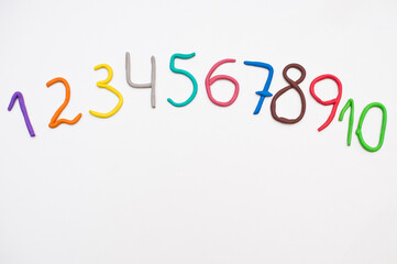 Colorful digits made from plasticine. Bright colored volumetric figures for children (isolated on white)
