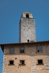 Fototapeta na wymiar The historic center of San Gimignano, a typical medieval village in Tuscany. Narrow streets, numerous stone towers characterize the urban landscape
