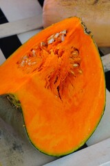 Colorful cut slice of orange pumpkins at a farmers market