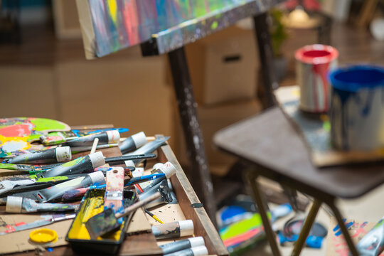 Drawer,cabinet of the artist, painter with scattered, disordered paints in a tube, paint brushes, paints artistic mess in the paint store, in the studio.