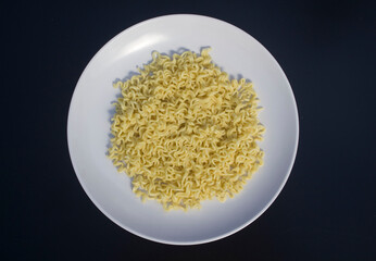 noodles in a plate isolated on a black background