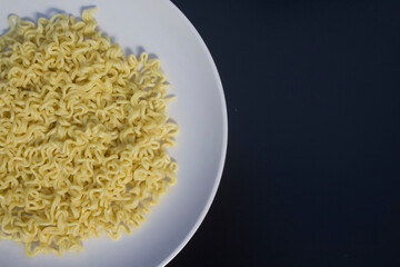 noodles in a plate isolated on a black background