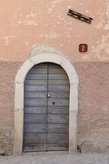 Pink Aged House Facade Detail with Old Wooden Door, Central Italy