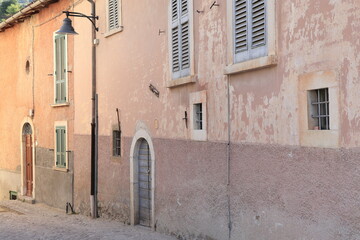 Street View with Historic Pink House Facades in Rural Village, Central Italy