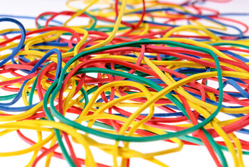 Colorful rubber bands close up on white background