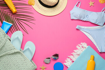 Frame made with different beach objects on pink background, flat lay. Space for text