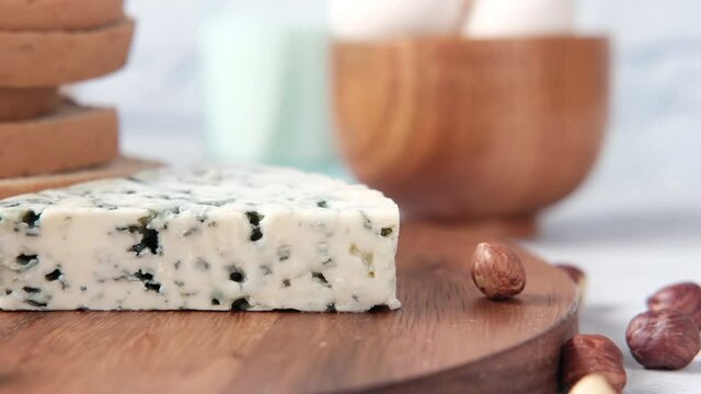 cheese, milk , brown bread and almond nut on table.