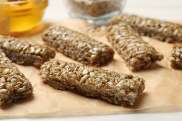 Delicious sweet kozinaki bars on parchment paper, closeup