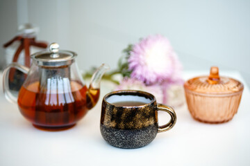 Obraz na płótnie Canvas still life with teapot, cup and flowers