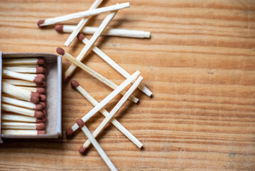 Matches in box on old wooden background. Closeup shot. Matchsticks in open match-box flat lay,copy space.Selective focus