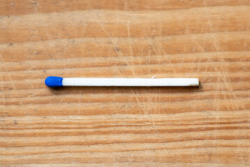 Closeup blue match on a wooden background with clipping path.matchstick flat lay,copy space,selective focus.