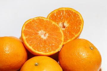 Cross section of mandarin orange fruit on white background. Health benefits of fresh oranges are excellent sources of vitamin C.