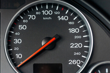Speedometer in a car. Car dashboard. Dashboard details with indication lamps.Car instrument panel. Dashboard with speedometer, tachometer, odometer. Car detailing. Modern interior.Closeup shot.