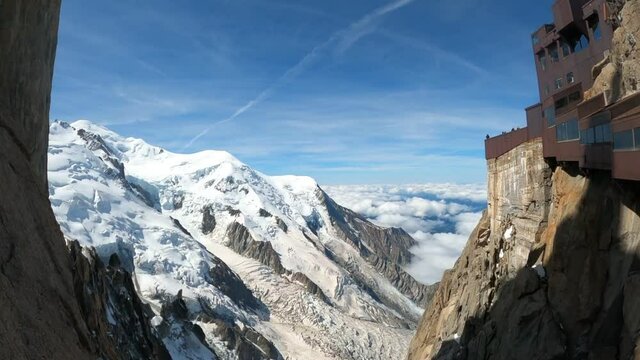 Alpinists reaching top of Aiguille du midi, chamonix, in Swiss Alps. Sport at the snowy mountains in Europe. 