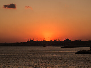 View from the sea druing sunset over the mosque