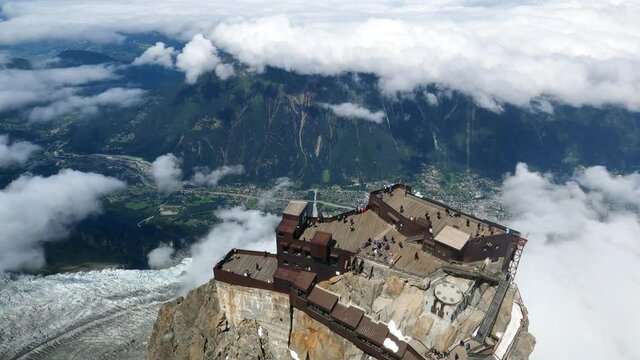 Alpinists reaching top of Aiguille du midi, chamonix, in Swiss Alps. Sport at the snowy mountains in Europe. 