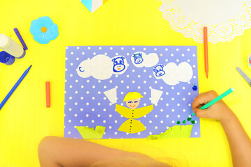 Child making card with funny cows and smiling child with glasses of milk, Creative  play with craft. The healthy food theme development of children.  School education handmade creativity.