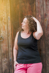 Woman with curly hair straightening her hair.