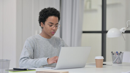 African Woman Working on Laptop in Office 