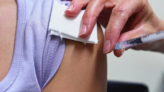 Doctor doing Covid 19 virus vaccine injection 