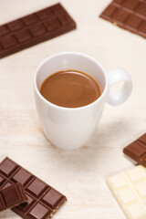 A lot of variety chocolates bar in box on white wooden background