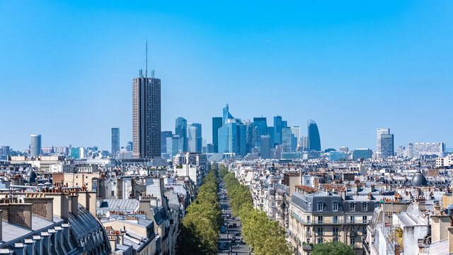 Paris, aerial view of La Defense and the avenue des Ternes,  haussmann facades and roofs in a luxury district of the capital
