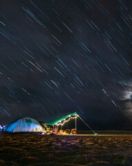 Night in tent on sandy beach under the stars