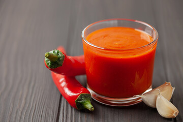Freshly Sriracha Hot chilli Sauce in bowl on wooden background.