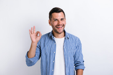 Everything is fine. Satisfied bearded man showing ok gesture with fingers, approving work, satisfied with quality. Indoor studio shot isolated on white background