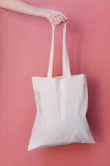 White tote bag on pink vertical background.