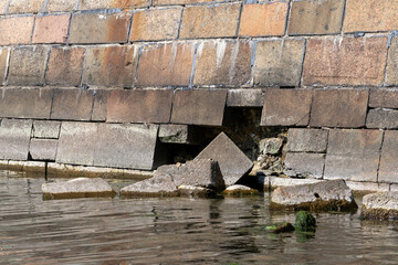 Riga, Bolderaja pier. The stone blocks on the pier wall have crumbled and fallen next to the pier,...