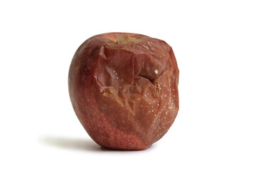 rotten apple on a white background. The bottom line is improper storage of fruits, spoiled foods, fruit diseases. Horizontal photo. Close-up.