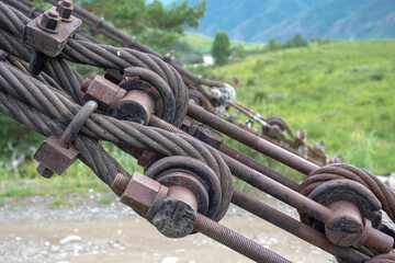 Structural elements of a suspended metal bridge over the Katun River