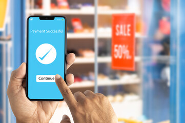 Man using smart phone for online payment, banking in store background. E-commerce, market, and shopping online concept.