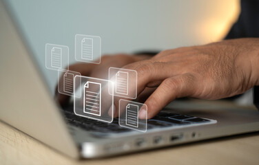 Hand press on keyboard with document icons and typing to laptop computer. Managing digital files and sending digital files. technology and business concept.