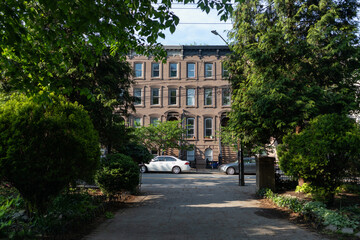 Walkway at Van Vorst Park with a Row of Old Brownstone Homes in Jersey City New Jersey